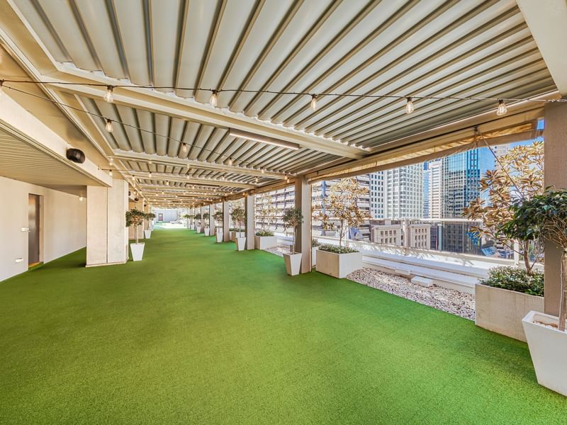Rooftop garden with artificial grass and skyline view in Soiree Deck at Sofitel Brisbane Central