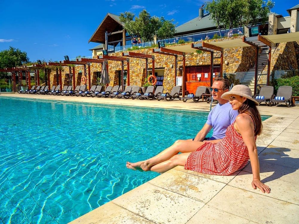 A couple is Enjoying the pool view at Pullman Bunker Bay Resort