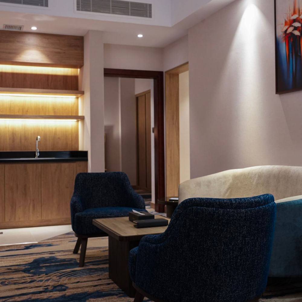 Cozy seating area with modern decor and artwork in the One Bedroom Suite at Warwick Hotel & Spa - Jeddah.