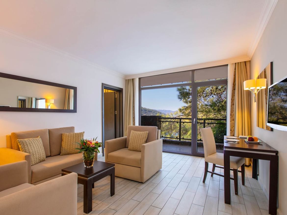 Living area with a balcony view in suite room at Marmaris Bay