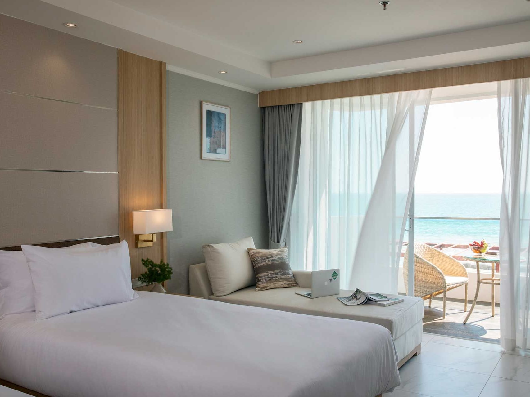 Comfy bed with balcony view in Superior Seaview Room at Eastin Resort Rayong