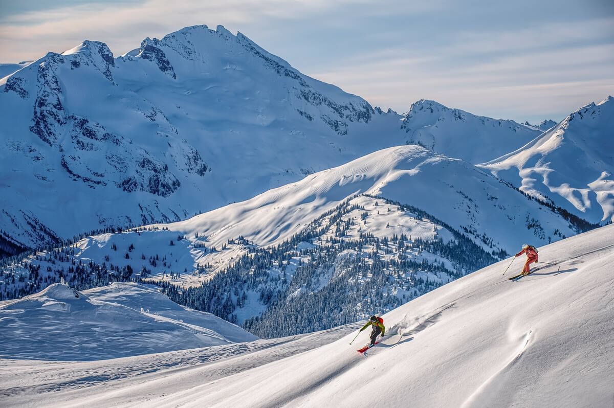 People skiing on mountains near Blackcomb Springs Suites
