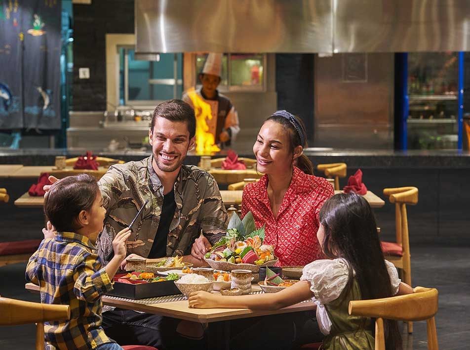 parents and children enjoying a family meal at the hotel restaurant - Lexis MY