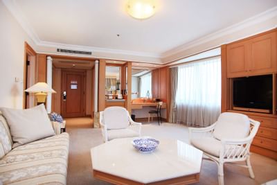Club Suite with couch, stylish table, TV at Hanoi Daewoo Hotel