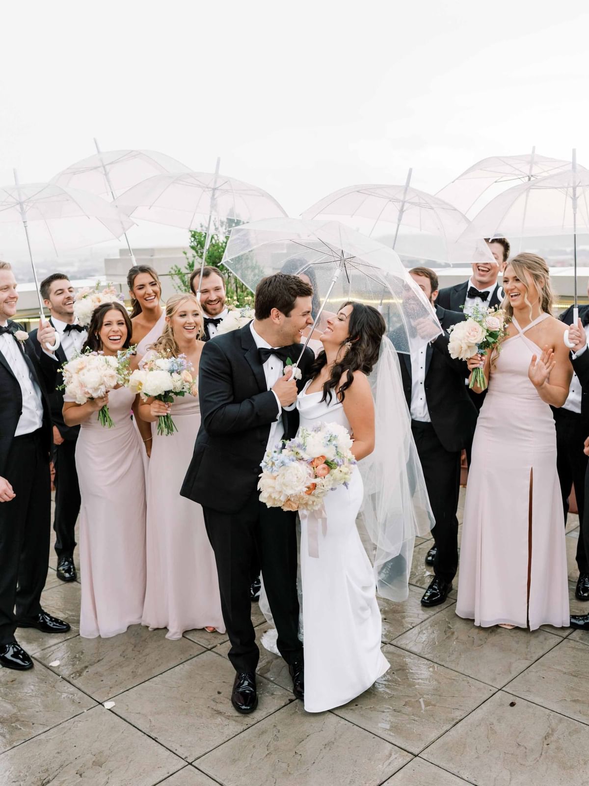 Wedded couple with friends posing rooftop at The Mayo Hotel