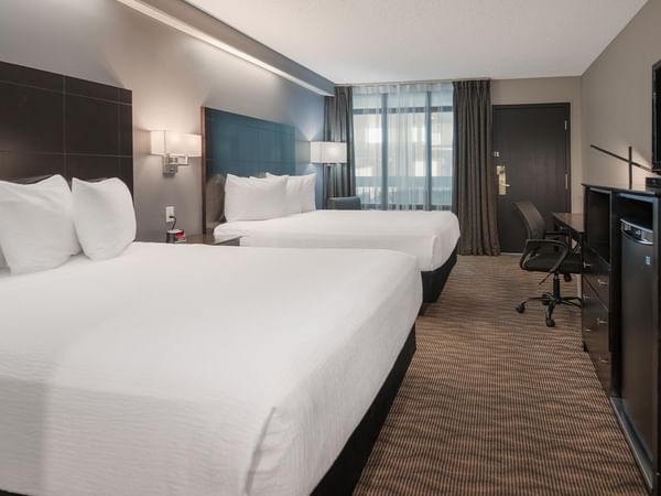 Two queen beds, TV, desk, and chair.