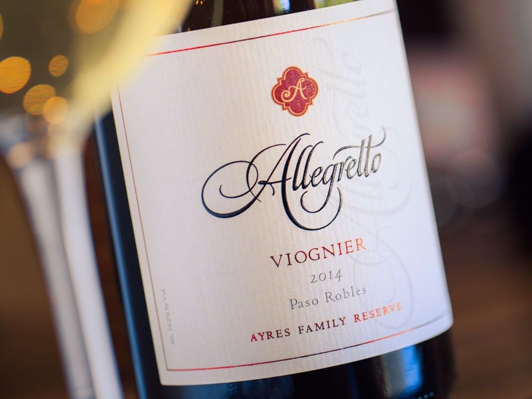 Allegretto wine bottle with glass of white wine