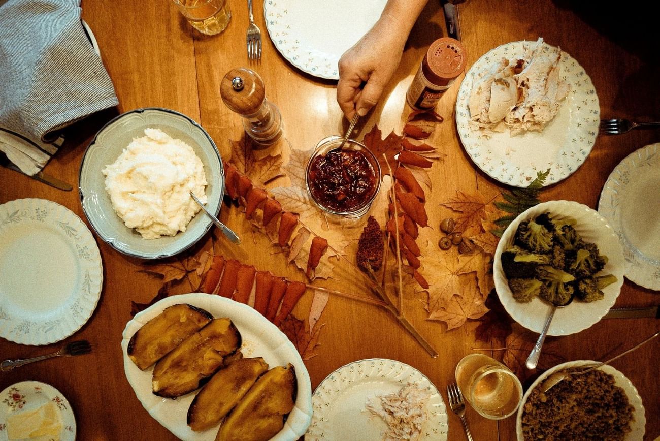 Overhead view of a Thanksgiving dinner table set with turkey, mashed potatoes, and served at The Grove Resort & Water Park