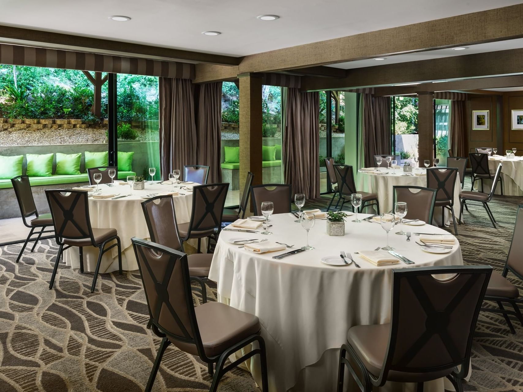 Tables and chairs arranged for dining at Luxe Sunset Boulevard