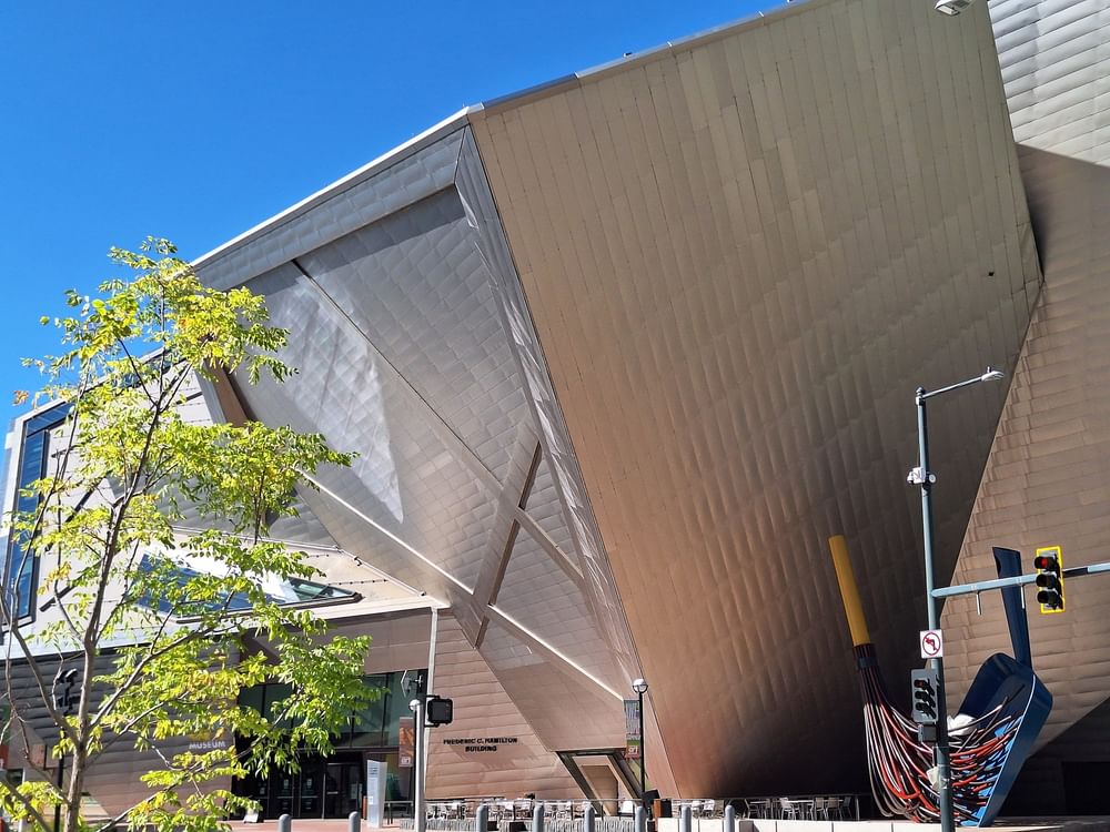 Museum Denver by a green tree under a clear sky in the city center near Warwick Denver