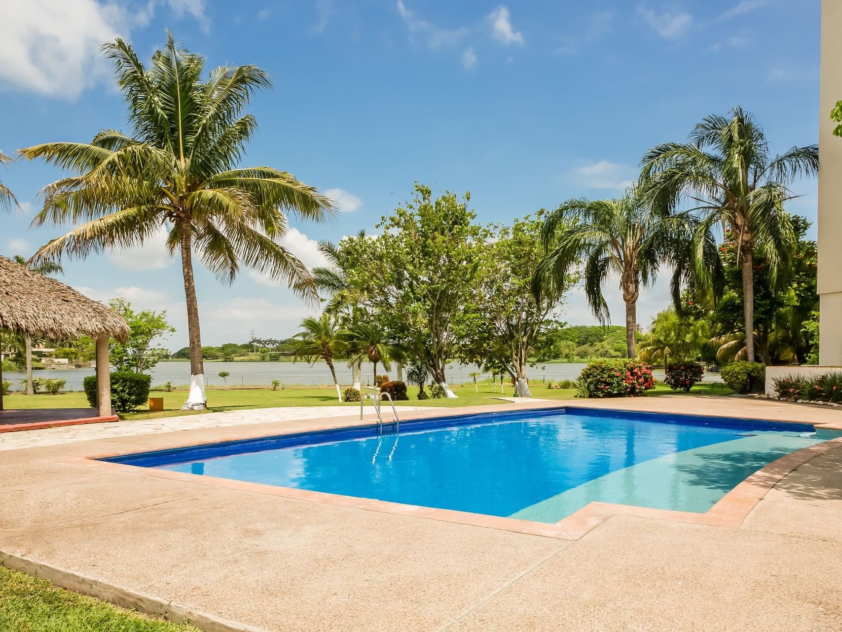 Outdoor swimming pool with a garden view at Fiesta Inn Hotels