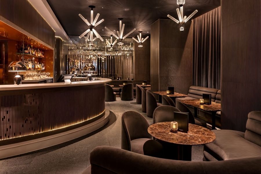 Elegant modern May Fair Bar featuring plush seating, marble tables, and ambient lighting at The May Fair Hotel