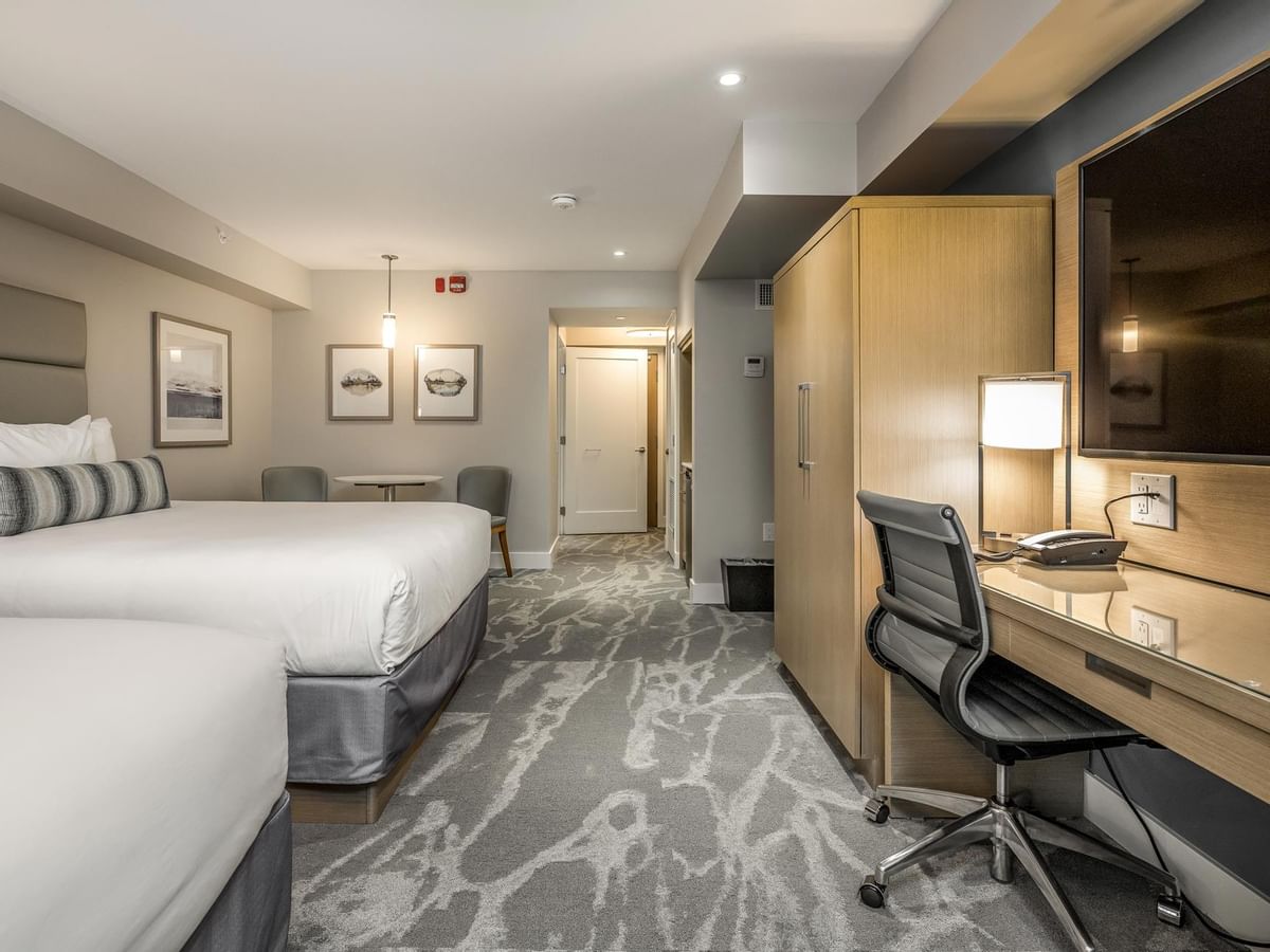 View of two queen beds, work desk and tv in our Coast Accessible Two Queens Bedroom