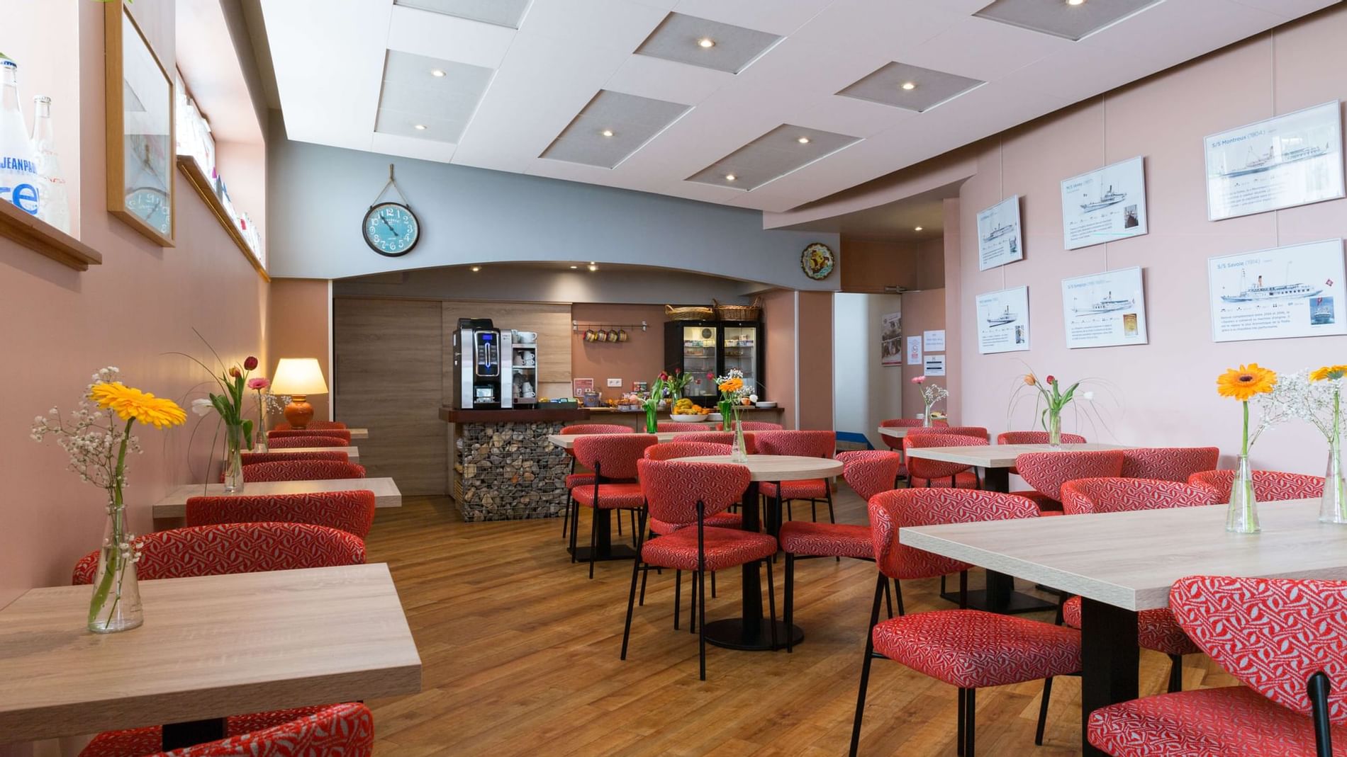 Dining tables with vases in the restaurant at Originals Hotels