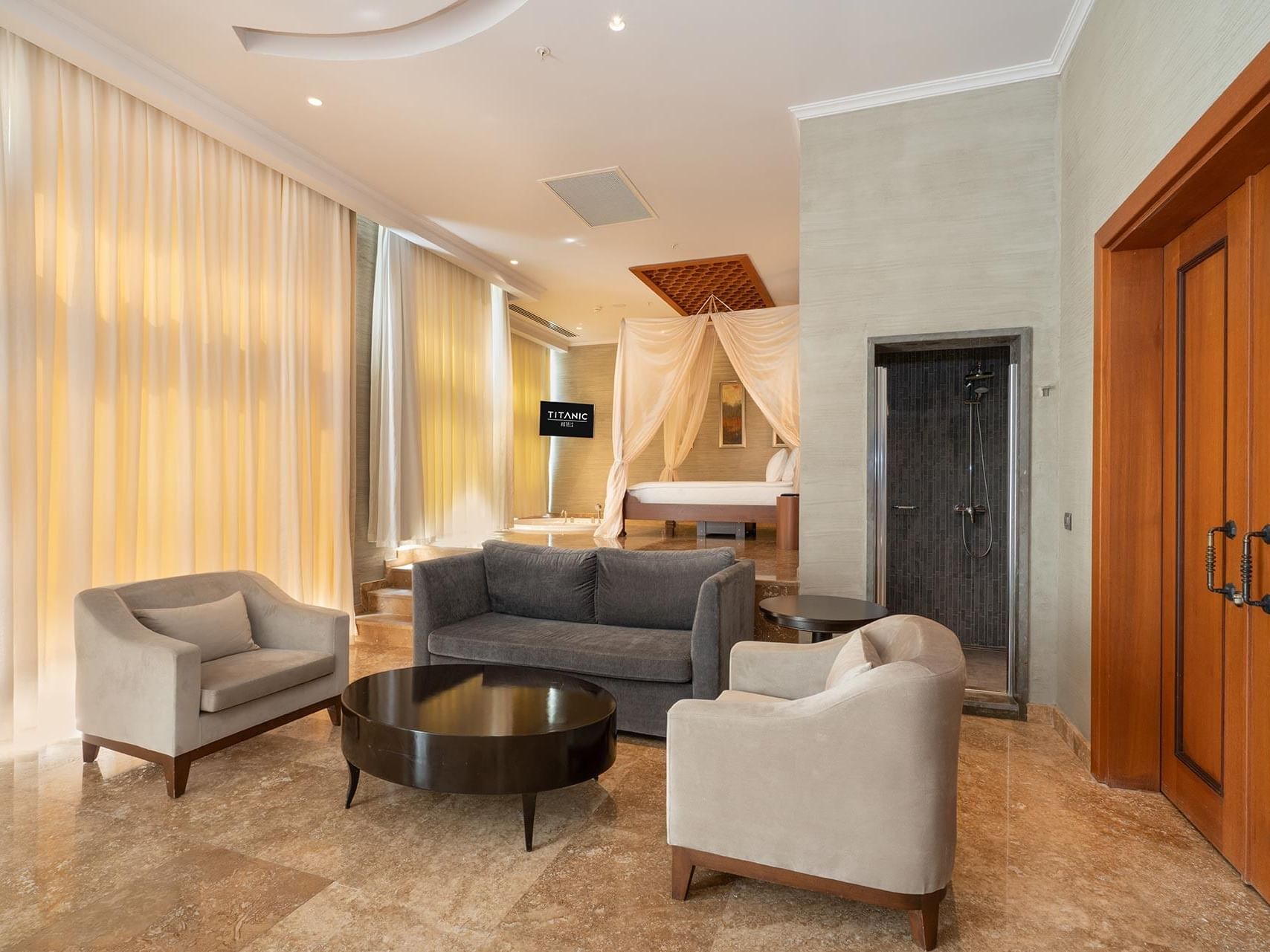 Living area and comfy bed in Ottoman Spa Suite at Titanic Deluxe Golf Belek