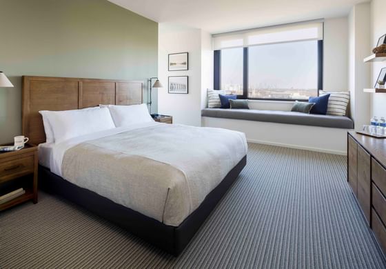 Comfy bed and plush window seat in King Study at The Study at the University of Chicago