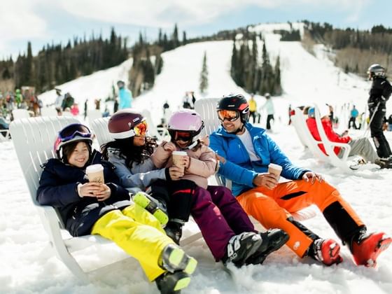 Family lounging on snow on a Ski Day near the Chateaux Deer Valley