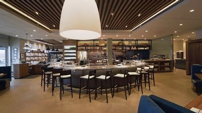 bar stools line a bar