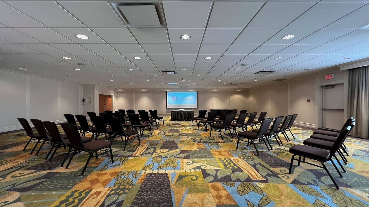 Chairs facing presentation screen in spacious room