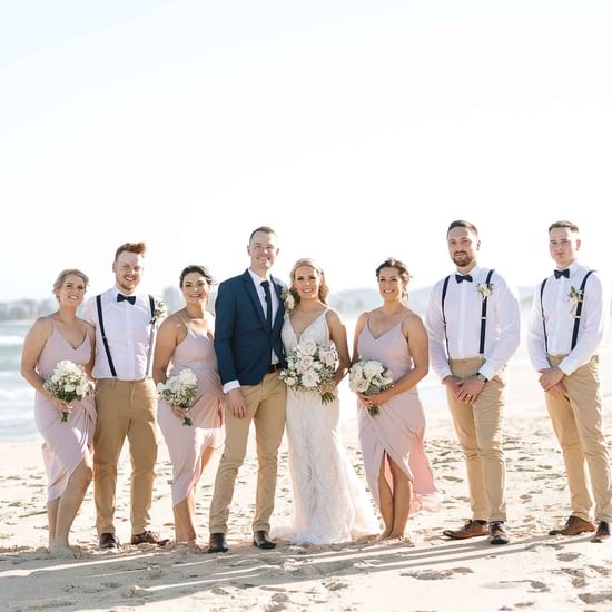 Wedding couple taking photos with crew near Pullman Magenta Shores