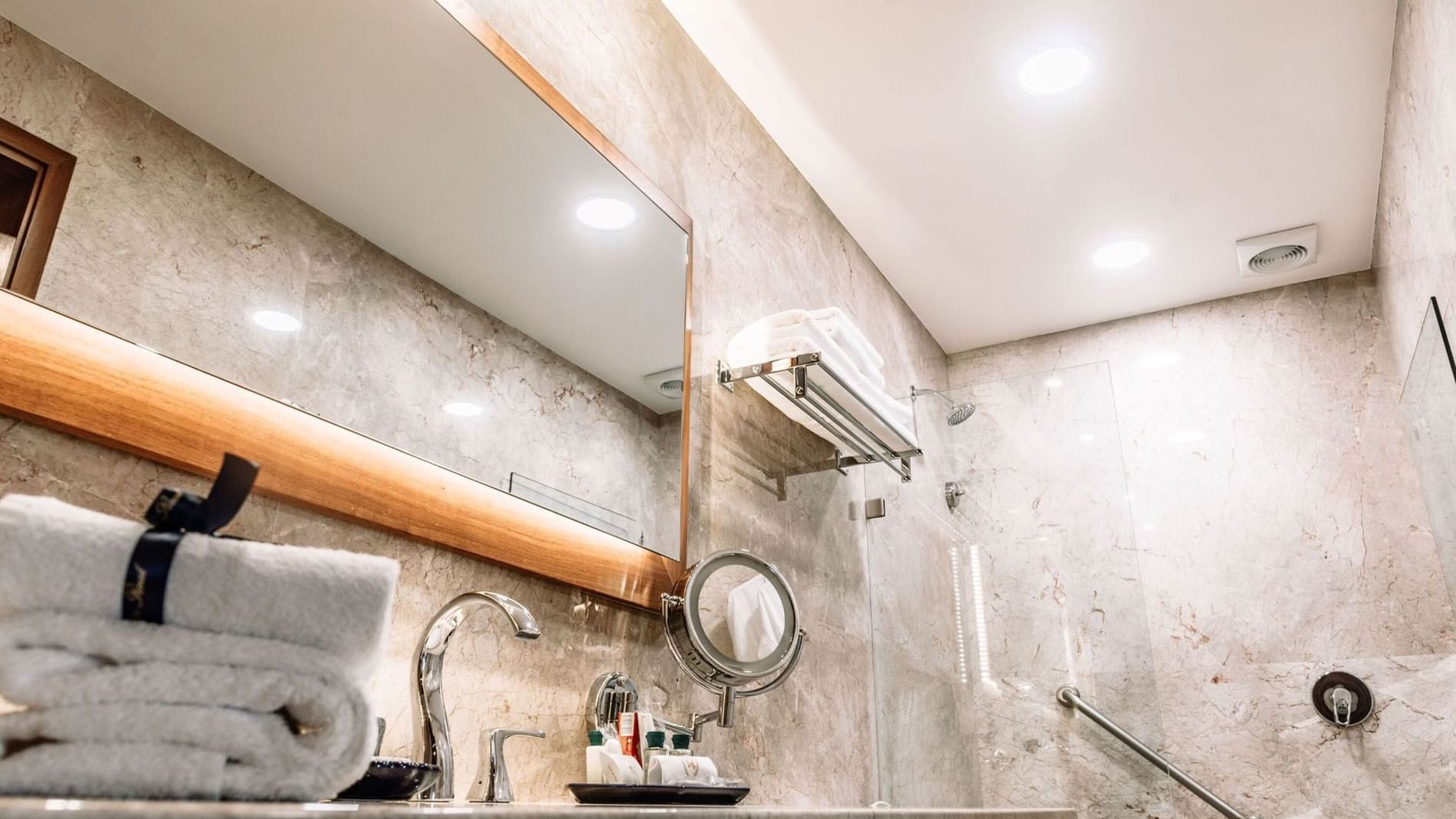 Bathroom counter with amenities and shower area in the 2 Double Grand Class Suite at Quinta Real Oaxaca