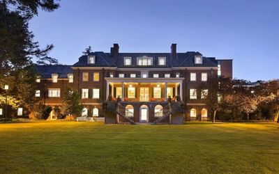 Illuminated backyard facade and manicured grass at Spencer Hotel & Conference Centre, one of the historic hotels Ontario
