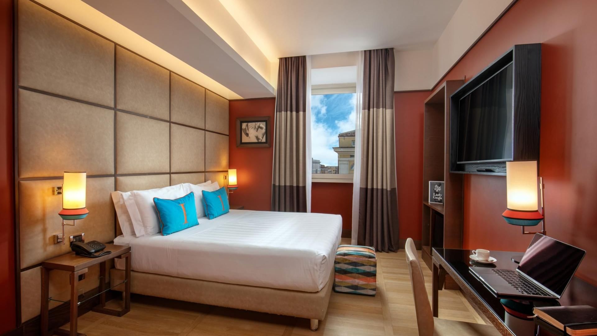 Modern Classic Room with a queen bed, desk, TV, and large windows with a city view at The Independent