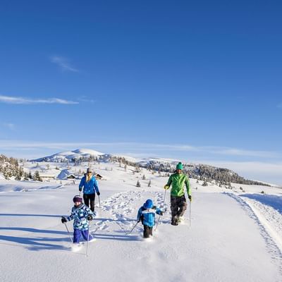 A family while winter walking near Falkensteiner Hotels