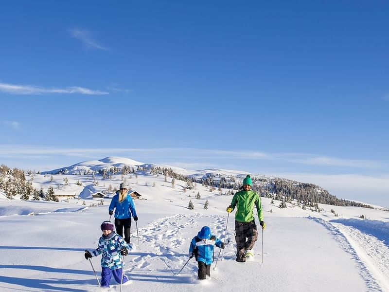 A family while winter walking near Falkensteiner Hotels