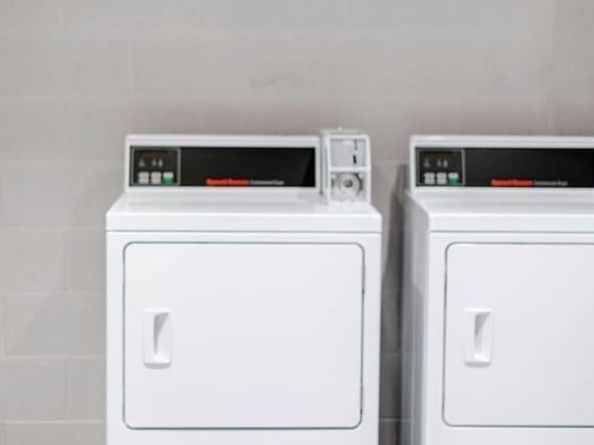 Close-up of laundry machines used at Brady Apartment Hotel Hardware Lane