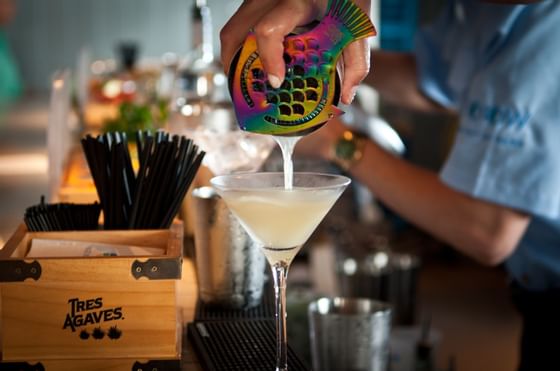 Bartender pouring cocktail