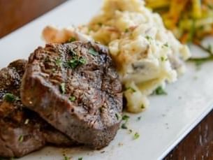 Steak and mashed potatoes on plate