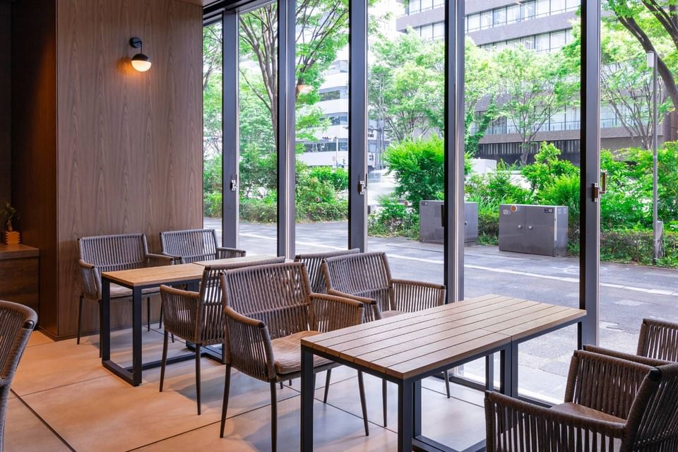 Dining table arrangements with outdoor view in Oike Café at Park Hotel Kyoto