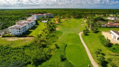 Aerial view of La Estancia Golf & Country Club surrounded by lush greenery near The Hub Acunmeyda