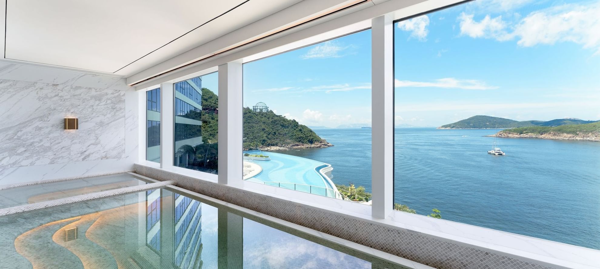 Indoor pool overlooking a body of water in The Fullerton Spa at Fullerton Ocean Park Hotel Hong Kong