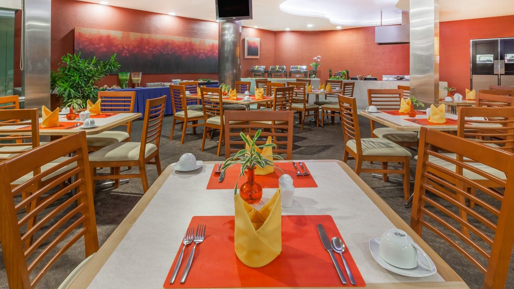Dining tables in a Restaurant at Gamma Colima Garden