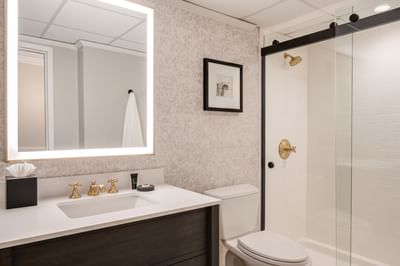 Vanity with mirror & lavatory in Rooms at The Madison Hotel