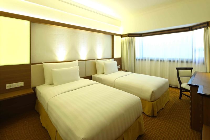 Work desk by the beds in Superior Twin Room at Sunway Hotel Hanoi