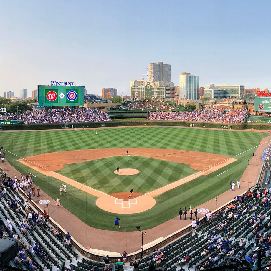Crowded Wrigley Field during a baseball game with players on the field.