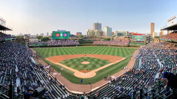 Crowded Wrigley Field during a baseball game with players on the field.
