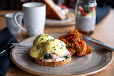 Plate of Eggs Benedict served on a table in The Lodge at Schroon Lake