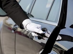 Close-up of concierge opening a car door at Pensativo House Hotel