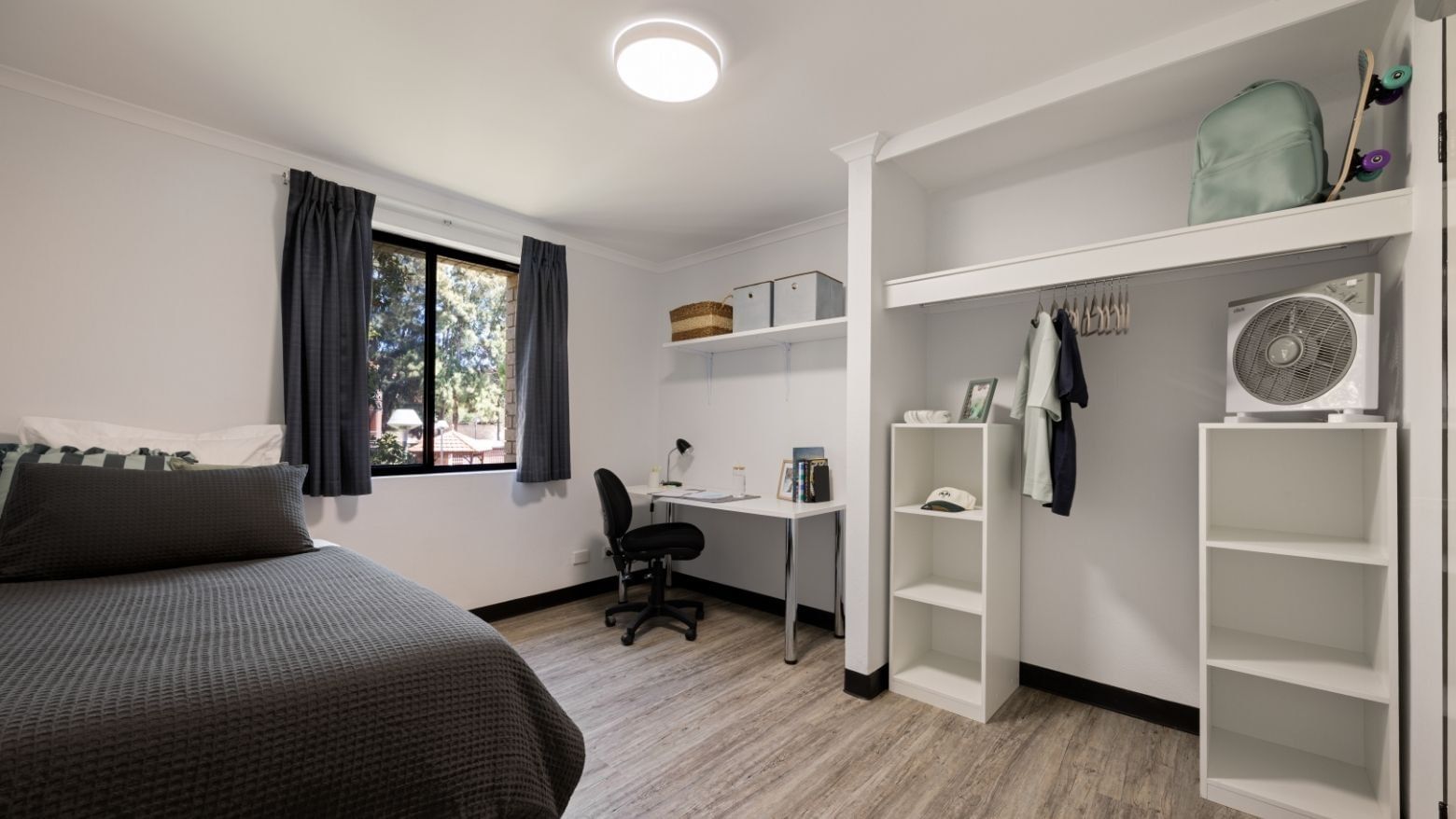 A neat room with bed, desk, chair, shelves, and closet at UniLodge at Curtin University - Erica Underwood House.