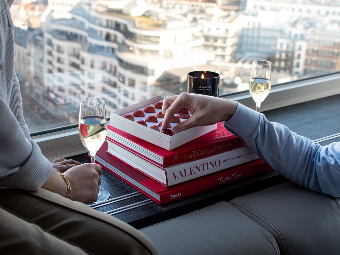 A couple having champagne and sweets at The Hotel Brussels