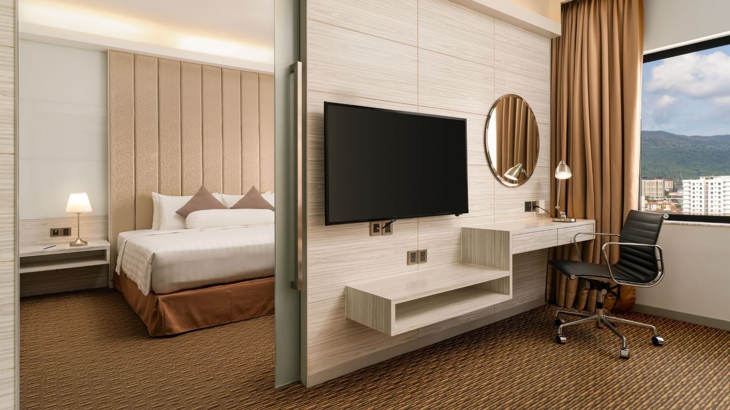 Wall-mounted TV and workspace by the bedroom in Executive Suite King at Sunway Hotel Georgetown