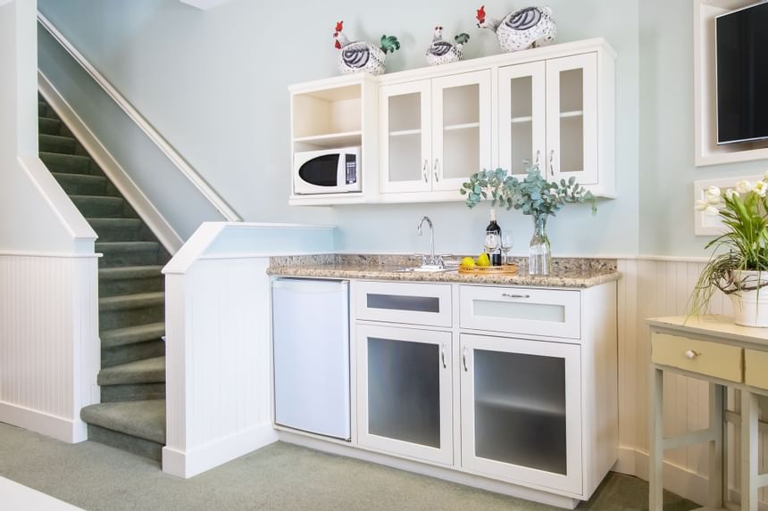 Kitchenette with pantry, appliances & stairway in Premiere Loft Nantucket at Retro Suites Hotel