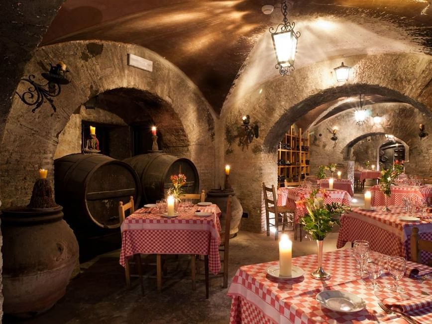 Cozy restaurant nestled in a cave in Bettoja Wine Cellar at Bettoja Hotel Massimo D´Azeglio