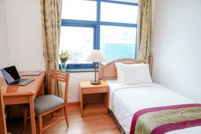 A room with works space and a single bed at Hanoi Daewoo Hotel