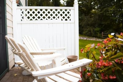 White wooden chairs on a patio