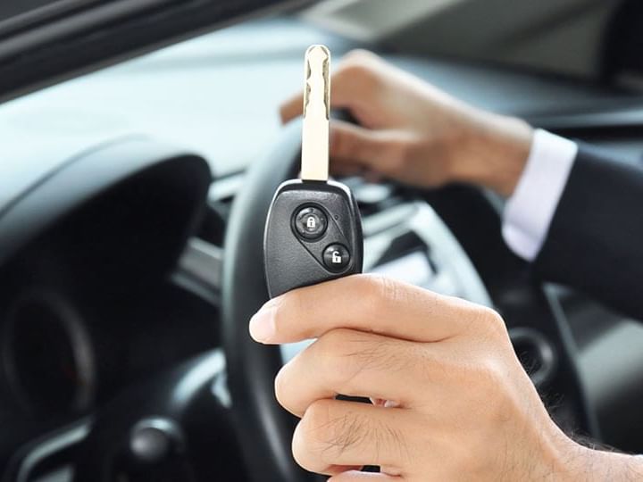 Holding car key featuring car rental facility at Luxury Suites Amsterdam